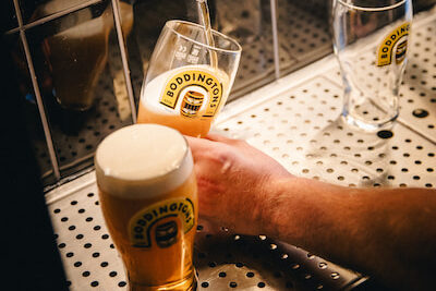 A beer being poured using a self service beer tap.